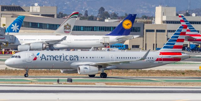 Airbus A321 (N127AA) - AAL2223 waits for clearance to cross runway 25R after arriving from Chicago OHare