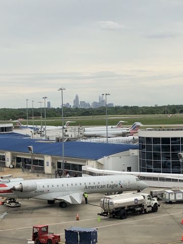 — — - AA RJ’s a KCLT “E” concourse with Charlotte skyline.