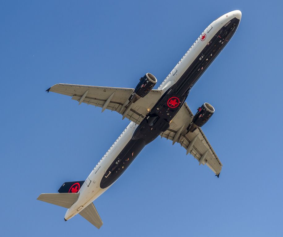 Airbus A321 (C-GJWI) - ACA140 pulls up and goes around due to a tardy exit of the previous landing aircraft.