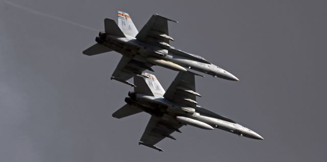 McDonnell Douglas FA-18 Hornet — - Now THIS is what I call a "Wingman" for sure! Look at how close the wingman is.br /br /And ... look at how low they are. True, I was standing on top of Rattlesnake Mountain when they came blistering in out of the south behind me so I was already quite high in the sky. And because I was looking down at RNO to the northwest of my position, I was not prepared to have a pair of Hornets come haulin' ass from behind me. Gotta say, when I got to the top of The Snake and looked down at RNO and saw that there was nothing there (33 flights canceled yesterday), I was figuring it was a wasted trek -- but then, WHAMMO! These two came out of nowhere and blasted by so close above me I simply could not stay on them while simultaneously aiming overhead and spinning around 180 degrees from south to north as they went past. And it was windy up there even before they came by, but I swear I was pushed around by their jet blast within seconds after they went past.br /br /Judging solely by the diamond shapes in the band along the top of the tail, these two are VMFA 323 "Death Rattlers."