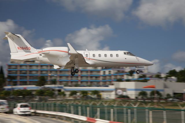 Learjet 60 (N294DD) - Low over the fence for a smooth landing on Rwy 10 at Sint Maarten - 5 Jan, 2013.  Learjet 60