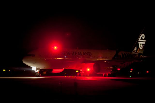 BOEING 737-300 (ZK-OKE) - The red strobes of B773 ZKOKE overpower the night and the camera as she taxies down Taxiway Alpha for Runway 02 at Christchurch Airport. She was returning back up to Auckland after having diverted a few hours earlier down to NZCH from Auckland due to bad weather. She had come over from Brisbane Australia on 6 Jul 2017, and along with 4 other B777s and 2 A330s had all diverted down to us as Auckland had a bad weather bomb passing over the airfield with many lightning strikes at their arrival times. The weather prevented most landings and any refuelling. So, for us at NZCH, we had a wonderful freezing cold evening down at the fence shooting rarities to this neck of the ANZ woods.