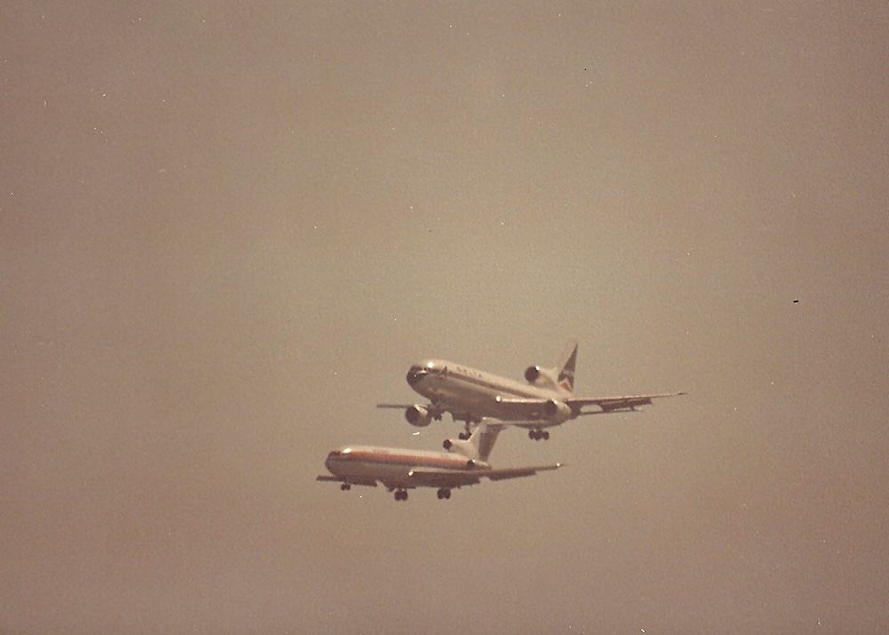 BOEING 727-200 — - KSFO - B727 and a Delta L-1011 on dual approach to runways 28 L/R in this late 1970s early 80s photo from Bayfront park- 35mm Minolta X7 1000mm Celestron Lens, long before the days of Digital lens and Ben Wang photos. Love that Flightaware watermark on the photo...................not!