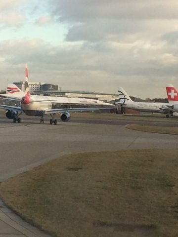 — — - In the back the BAW Concorde sits aside the busy taxi way at London Heathrow