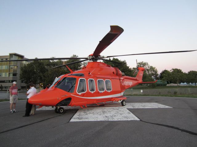 C-GYNM — - I was so excited when passing by Kingston general hospital, I saw the ornge bird sitting on the helipad.  I was even more excited when the crew asked me if I wanted to come and take picutres of the aircraft! Id like to thank the crew for making this amazing shot possible!