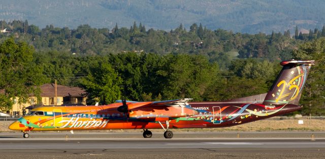 de Havilland Dash 8-400 (N425QX) - Yep, I know this one has been junked, and I understand the reasons why, but it sure was a fabulously colorful sight to catch on camera, especially on a nice sunny morning.br /QXEs now-scrapped N425QX, decked out in Horizons "25th Anniversary" livery, is shown here a few years ago as it taxied south toward runway 34L at Reno Tahoe International on a bright sunny summer morning.  Within 15 months of this capture, repeated and costly MX issues with this particular fleetbird would result in it being wfu and (I think) it was eventually sliced up.