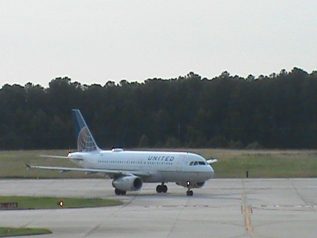 Airbus A319 (N843UA) - United Flight 474 From KORD is taxiing down the road after landing 5L at KRDU. Taken 6/20/2013.