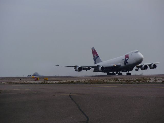 Boeing 747-200 (G-MKBA) - This guy had some tyre missing and holes on the underbelly when he T/O...     Story:  On dep from some place in Asia, he hit some debris at speed and caused a massive chunk of tyre to bounce down the under belly of the aircraft causing holes, on landing he broke at such a force the pads were smoking. At a closer inspection it was found the tyre was ok (as it didn’t penetrate all the way though the tyre lining). All they did was put metal tape over the holes and took off again to get a new tyre and proper repair work on the belly.