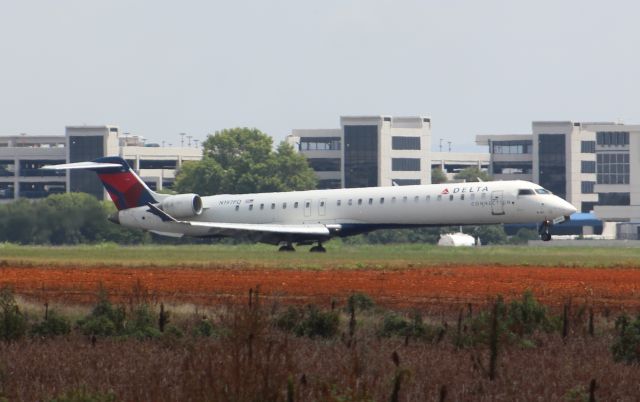 Canadair Regional Jet CRJ-900 (N197PQ) - Landing in the heat haze on Runway 18R @ Huntsville International...