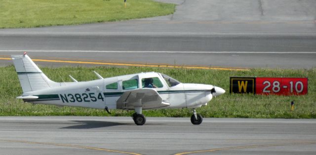 Piper Cherokee (N38254) - Taxiing to parking is this 1977 Piper Cherokee Archer II in the Spring of 2022.