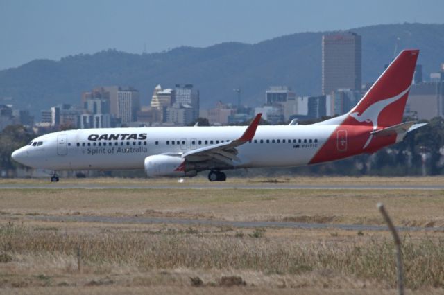 Boeing 737-800 (VH-VYC) - On taxi-way heading for Terminal 1, after landing on runway 23.Part of the Adelaide city skyline can be seen in the background. Thursday 4th April 2013.