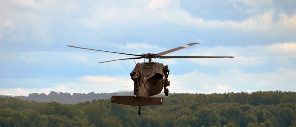 — — - A Minnesota Army National Guard UH-60 Black Hawk landing in downtown St Paul ( airport ) Looking South East. over the Mississippi river.