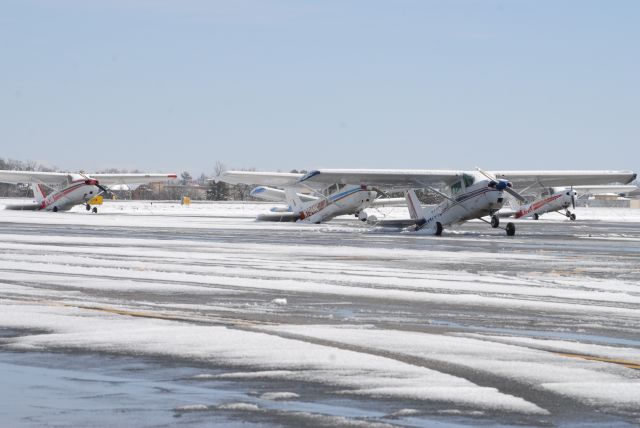 Cessna Skyhawk — - Thank god my plane is in a hangar!  This is a photo of a few Cessnas the morning after the Greenville, SC snowstorm.  Who knew a Cessna could transform itself into a taildragger!