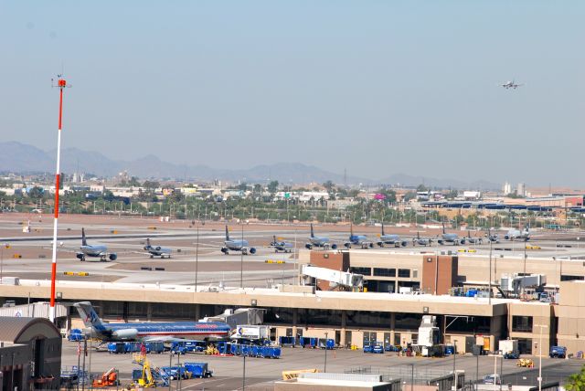— — - Air Force One at PHX Causes Traffic Jam on Runways:    Before the Presidential motorcade even arrived at the airport, the North side of the airport was completely closed down to all air traffic. All takeoffs and departures were on the South runways only. With the two South runways relatively close together, they could only launch or land one plane at a time; they had to alternate- one landing, one takeoff. As you can imagine, this led to some delays; at one point, I counted twelve planes lined up on the taxiway waiting to take off.