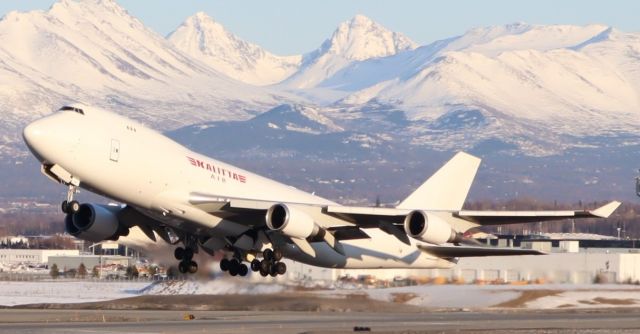 Boeing 747-400 (N401KZ) - Takeoff at sunset viewed from Pt. Woronzof Rd.  West side of N-S runway