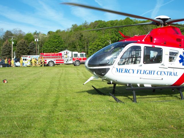 Eurocopter EC-635 (N935MC) - Awaiting a patient. Middlesex Valley Airport boasts a number of Piper Cub owners.