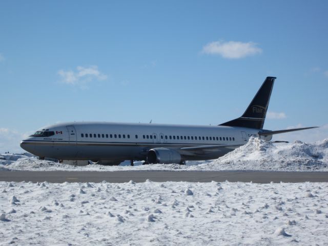 BOEING 737-400 (C-FLER) - Came up to ottawa for a basketball tournament, decided to stop by the airport, and was lucky to catch this Flair air 737-400 sitting flanked by piles of snow