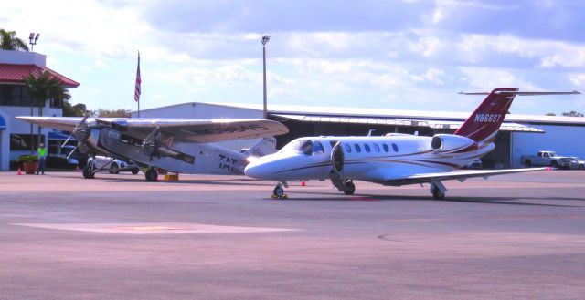 Cessna Citation CJ3 (N866ST) - The new and the 'old' (EAA Ford TriMotor in background)