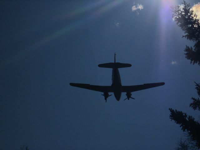 CURTISS Commando — - A C-46 on final. A nice silouette of her with the rays of the sun around her. (actual photo unretouched)