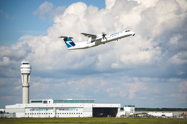 de Havilland Dash 8-400 (C-FENU) - Standing midfield near the old runway tower