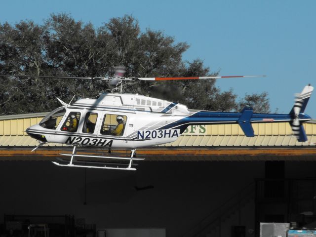 Bell 407 (N203HA) - HeloAirs Bell 407 landing at the US Forest Service hanger