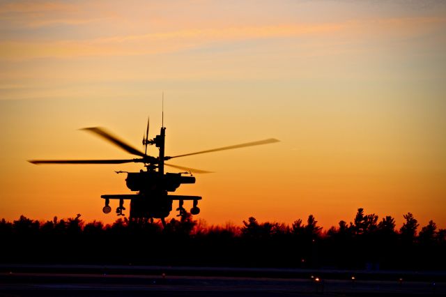 — — - An AH-64D Apache Longbow takes off into the sunset in upstate New York