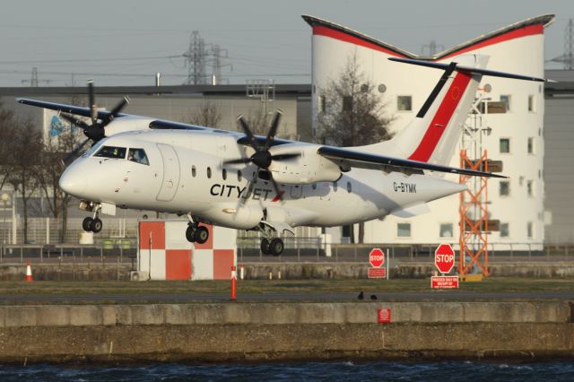 — — - A Cityjet, ATR-42, struggles with high winds, on approach to London City Airport.