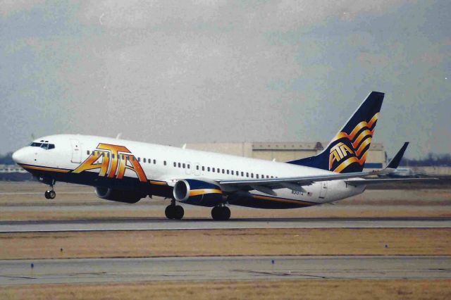 Boeing 737-800 (N313TZ) - Departing 23-L KIND. Note ATA hanger and L-1011 in the background.