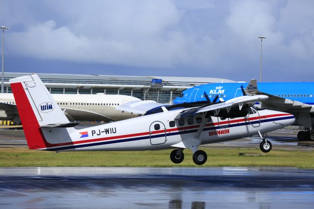 De Havilland Canada Twin Otter (PJ-WIU) - Winair departing P4-Mes taxing while KLM is also taxing.