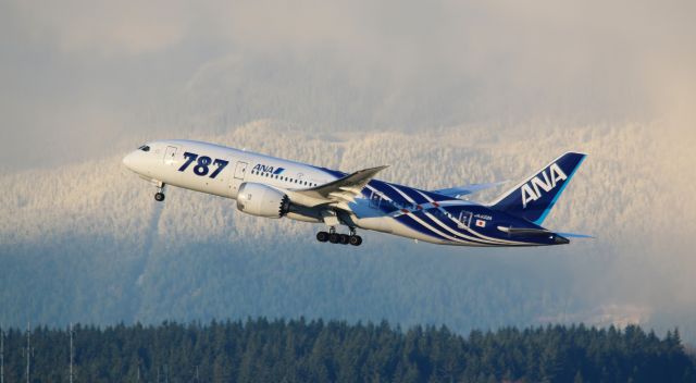 Boeing 787-8 (JA802A) - ANA All Nippon departure at YVR for HND with Vancouvers North shore mountains peeking through the clouds with fresh snow