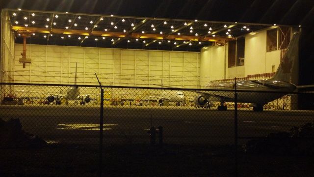 — — - A peak inside one of Air Canadas hangers. The B763 is being towed inside to meet the A319 and A321.