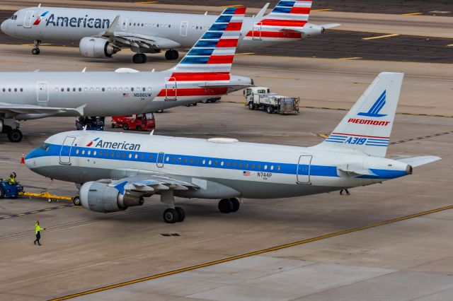 Airbus A319 (N744P) - An American Airlines A319 in Piedmont retro livery pushing back at PHX on 2/13/23, the busiest day in PHX history, during the Super Bowl rush. Taken with a Canon R7 and Canon EF 100-400 II L lens.