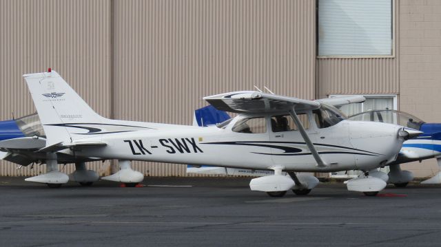 Cessna Skyhawk (ZK-SWX) - In front of a pair of Robins.