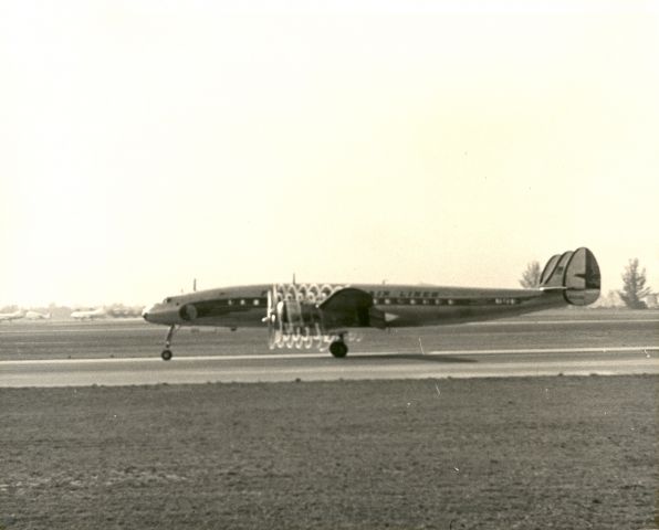 UNK — - Eastern Air Lines Constellation taxis in morning fog leaving condensation trails from the props 1954.