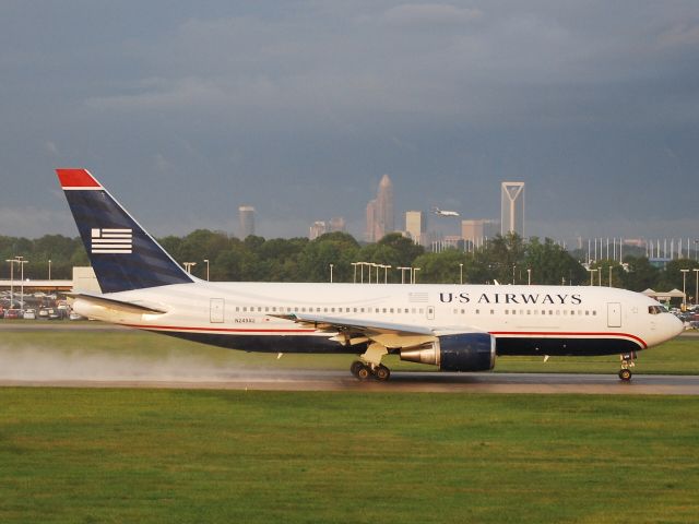 BOEING 767-200 (N249AU) - On takeoff roll 18C in rain and sun - 5/27/11