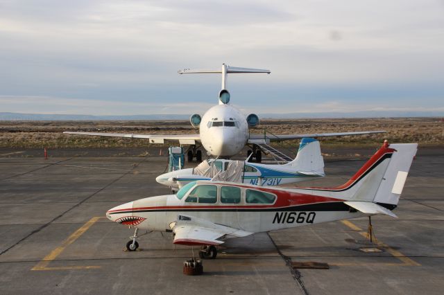 Beechcraft 55 Baron (N166Q) - Baron awaiting disassembly by the Big Bend Community College aviation program. In the back is an ex-FedEx 727 and a Beech 95 Travel Air.