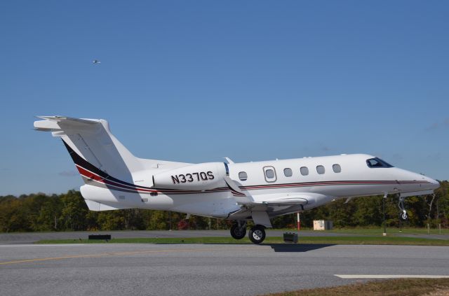 Embraer Phenom 300 (N337QS) - Departing Rnwy 8 after a short stop in beautiful Blairsville, GA.  Photographed adjacent to the runway.