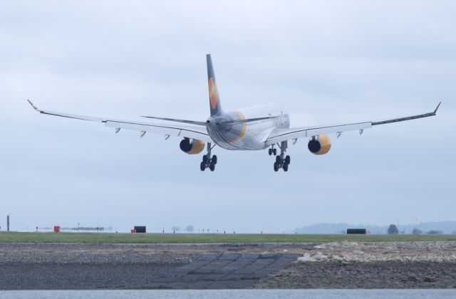 Airbus A330-200 (G-TCXB) - Thomas Cook Inaugural flight to Boston! Great turnout of spotters! 5/30/16br /Cool reflection of the runway threshold on the belly of the aircraft.