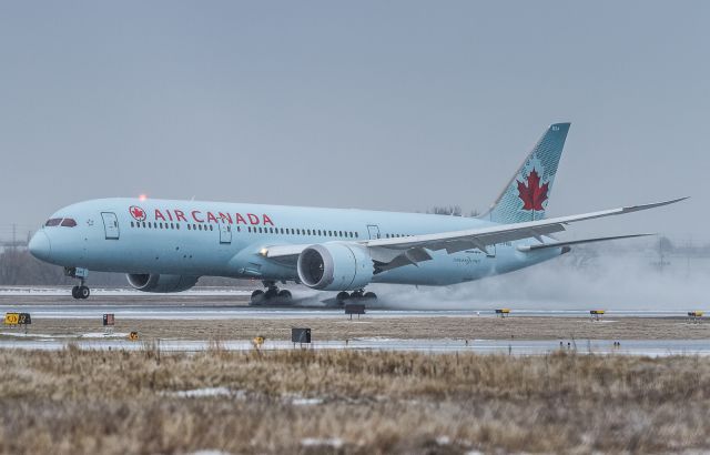 Boeing 787-9 Dreamliner (C-FNOI) - You can see the depth of the slush on runway 05 as AC851 splashes down and activates the thrust reversers to get slowed down. Arriving from Amsterdam.br /April 14th, 2018