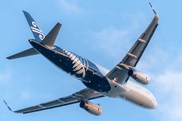 Airbus A320 (ZK-OXA) - A nice shiny AirNZ Airbus A320 climbs away from Runway 20 into the setting sun, bound for Auckland.