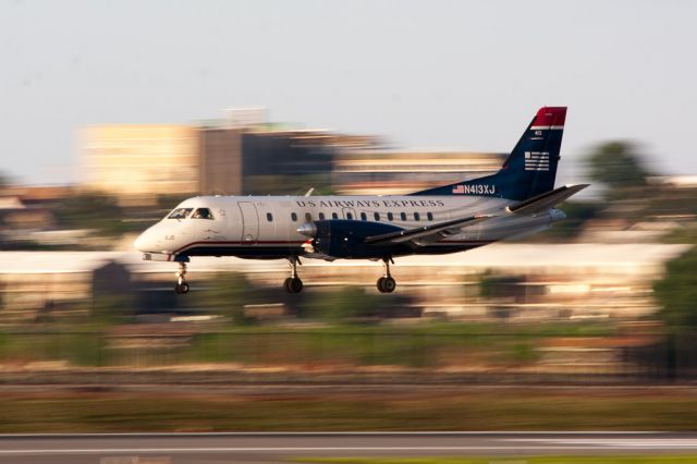 Saab 340 (N413XJ) - USX Saab 340 over the threshold of Runway 31 at LaGuardia