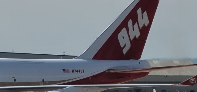 Boeing 747-400 (N744ST) - Global Super Tanker firefighting plane landed about an hour ago at San Antonio International Airport.  Image taken facing ST Engineering hangars from nearby parking garage.