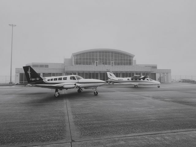 Cessna 402 (N660CA) - A Cessna 402C and Tecnam P2012 waiting for the fog to lift