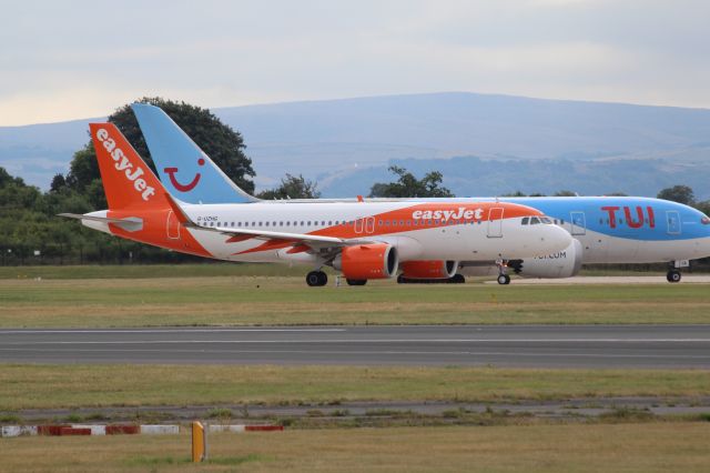 Airbus A320 (G-UZHG) - easyJet (U2) G-UZHG A320-251N [cn8243]br /Manchester (MAN).  easyJet flight U21847 awaits runway clearance for departure to Pisa Galileo Galilei (PSA). Seen behind is TUI Airways (BY) B787-8 G-TUIA also awaiting departure for Orlando Sanford (SFB)br /Taken from RVP Airport Viewing Parkbr /br /2018 08 04br /a rel=nofollow href=http://alphayankee.smugmug.com/Airlines-and-Airliners-Portfolio/Airlines/EuropeanAirlines/EasyJet-U2/https://alphayankee.smugmug.com/Airlines-and-Airliners-Portfolio/Airlines/EuropeanAirlines/EasyJet-U2//a