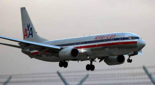 Boeing 737-800 (N902AN) - Arrival from KORD, on 12R,  just inside new FAA mandated 11 perimeter fence, landing to South. 02-03-2017