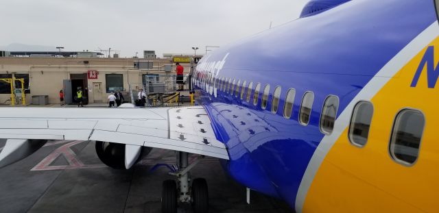 Boeing 737-700 — - I waited until the plane was empty so I could deplane through the back door. Have to take advantage of this when available. Not many places left without jetways.