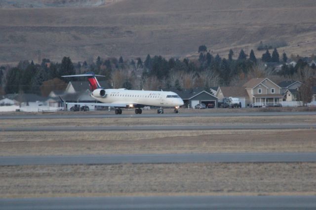 Canadair Regional Jet CRJ-700 (N713EV) - N713EV on runway 12 at Butte as SKYWEST 4312 to KSLC.br /br /Taken 18:09, November 2, 2024 with a Canon EOS T2i and 70-300mm (300mm, 1/250, ƒ5.6, ISO 3200)