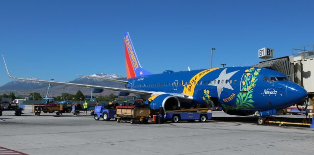 Boeing 737-700 (N727SW) - "Nevada One" (N727SW) was the second of Southwests special livery fleetbirds to pay a visit to Reno Tahoe International on the same day.  When I captured this one about two and a half hours after "Illinois One" (N918WN) departed (see the previous picture I just posted into the gallery), I had no idea that there would be even more SW special paintbirds stopping in at RNO in the next hours.  And, on the same day, over at the next concourse, QX (Horizon Airlines) was also putting on a show as several of their college-livery schemebirds paid visits.  It was a extremely "color-filled" day at RTIA.