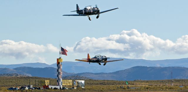 North American T-6 Texan (N4802E) - Two T-6s, "Gunslinger" (#66, N4802E, an AT6A owned and piloted by Vic McMann from Point Roberts, WA) and "Midlife Madness" (#54, N1364J, piloted by Michael Pfleger of Scottsdale, AZ) take to the air at the 2015 National Championship Air Races at Reno Stead Airport.