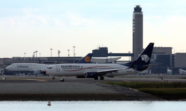 Boeing 737-800 (N845AM) - Aeromexic B738 taxis for departure (Note the United nose) while Lufthansa B748 departs in back. 